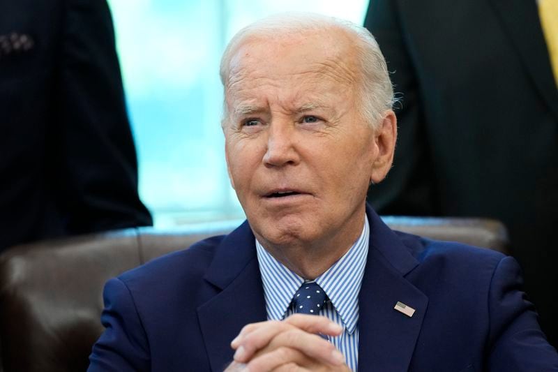 President Joe Biden, who is joined by civil rights leaders, community members, and elected officials, speaks after signing a proclamation in the Oval Office of the White House in Washington, Friday, Aug. 16, to designate the Springfield 1908 Race Riot National Monument. (AP Photo/Susan Walsh)