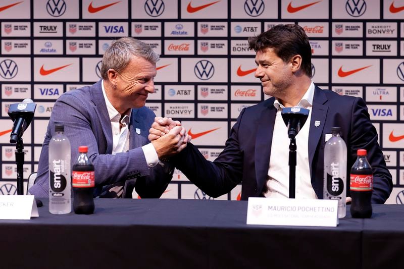 Mauricio Pochettino, right, the newly appointed head coach of the United States men's national soccer team, shakes hands with U.S. soccer sporting director Matt Crocker at a press conference Friday, Sept. 13, 2024, in New York. (AP Photo/Adam Hunger)