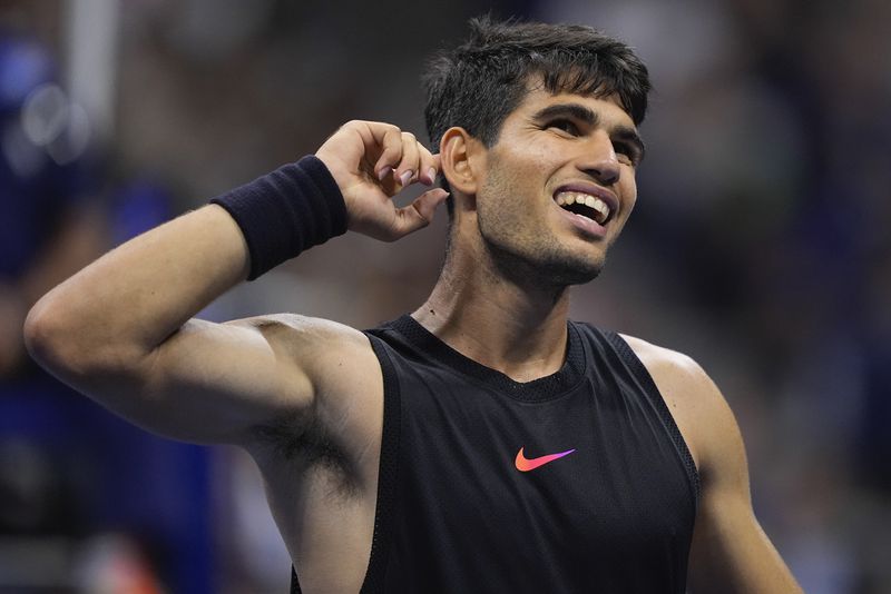 Carlos Alcaraz, of Spain, reacts during a match against Li Tu, of Australia, during the first round of the U.S. Open tennis championships, Tuesday, Aug. 27, 2024, in New York. (AP Photo/Matt Rourke)