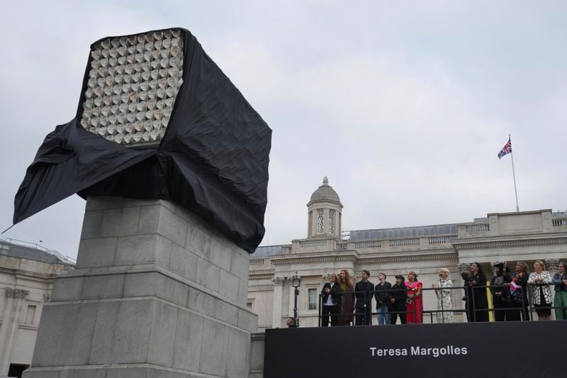 Mexican artist Teresa Margolles, fifth left, unveils her artwork "Mil Veces un Instante (A Thousand Times in an Instant)" on Fourth Plinth, marking 25 years of the ground-breaking commissioning programme for public art at Trafalgar Square, in London, Wednesday, Sept. 18, 2024. (AP Photo/Kin Cheung)