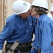 Former President Jimmy Carter sneaks a kiss with Rosalynn Carter as the couple works on a Habitat for Humanity build in Memphis in 2015. (Ben Gray/The Atlanta Journal-Constitution)