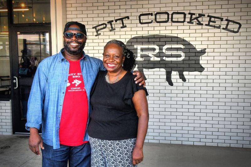 Rodney Scott and City Councilwoman Joyce Sheperd pose for a post-ribbon cutting photo as Scott opens his Atlanta location of Rodney Scott's Whole Hog BBQ in the Pittsburgh neighborhood near West End on Tuesday, July 27, 2021. (Chris Hunt for The Atlanta Journal-Constitution)