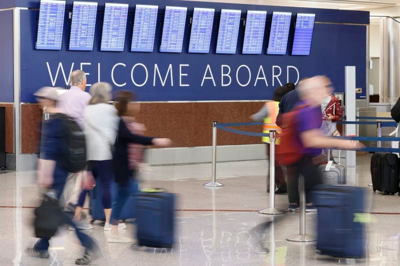 People pass through the South Terminal at the Hartsfield-Jackson International Airport on Thursday, May 26, 2022. About 2 million passengers are expected to pass through its concourses during the Memorial Day holiday from May 26 to June 1. Miguel Martinez / miguel.martinezjimene