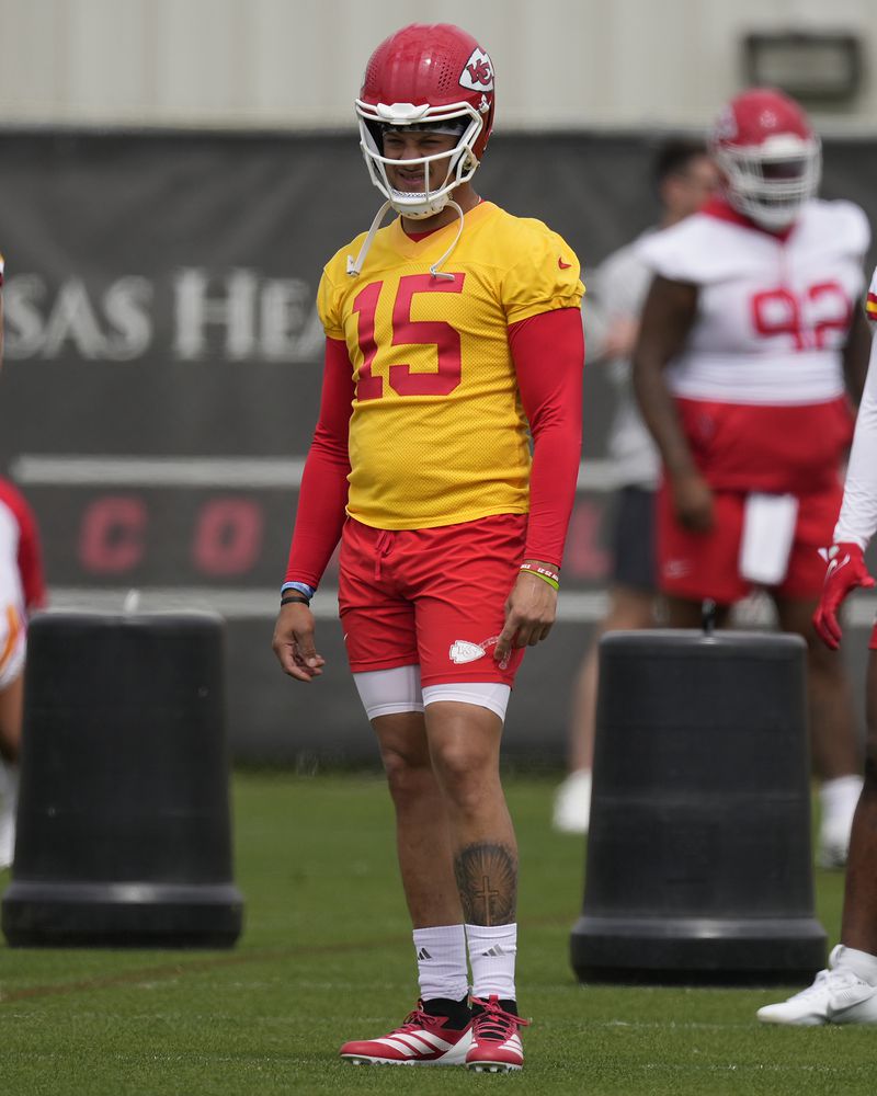 Kansas City Chiefs quarterback Patrick Mahomes watches a drill during the NFL football team's organized team activities Wednesday, May 22, 2024, in Kansas City, Mo. (AP Photo/Charlie Riedel)