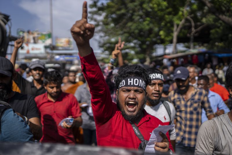 FILE - Protesters shouts slogans demanding acting president and prime minister Ranil Wickremesinghe resign in Colombo, Sri Lanka, in Colombo, Sri Lanka, on July 19, 2022. (AP Photo/Rafiq Maqbool, File)