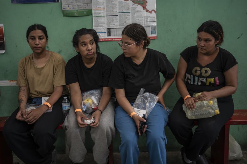 Venezuelan migrant Yeneska Garcia, second from left, sits with other migrants at the Peace Oasis of the Holy Spirit Amparito shelter in Villahermosa, Mexico, on Friday, June 7, 2024. "I would rather cross the Darien Gap 10,000 times than cross Mexico once," Garcia said. (AP Photo/Felix Marquez)
