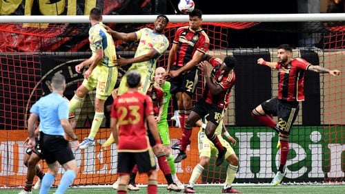 Atlanta United defender Miles Robinson (12) heads the ball away during the first half in an MLS match at Mercedes-Benz Stadium, Saturday, April 1, 2023, in Atlanta. (Hyosub Shin / Hyosub.Shin@ajc.com)