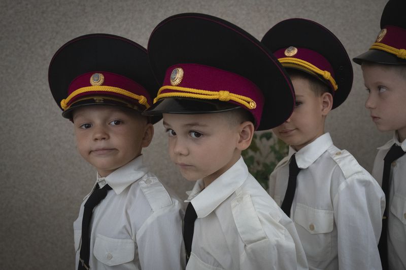 Young cadets get ready for a ceremony in a cadet lyceum on the first day at school in Kyiv, Ukraine, Monday, Sept. 2, 2024. Children and students went to school despite the fact that Kyiv was hit by massive Russian missile barrage early in the morning, causing fires, damaged buildings and infrastructure objects. (AP Photo/Efrem Lukatsky)