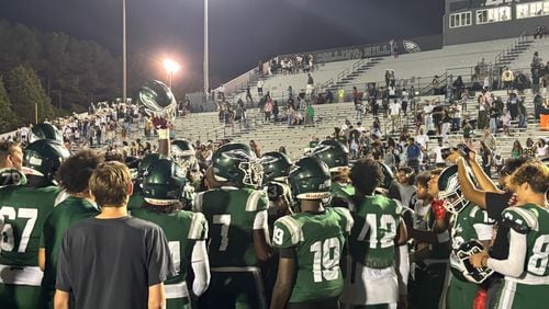 The Collins Hill football team celebrates after its 21-14 win over Woodward Academy, Aug. 24, 2024.