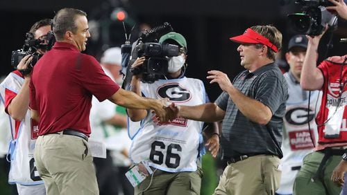 Georgia coach Kirby Smart shakes hands with South Carolina coach Shane Beamer after beating South Carolina 40-13 on Saturday, Sept 18, 2021, in Athens. (Curtis Compton / AJC file)