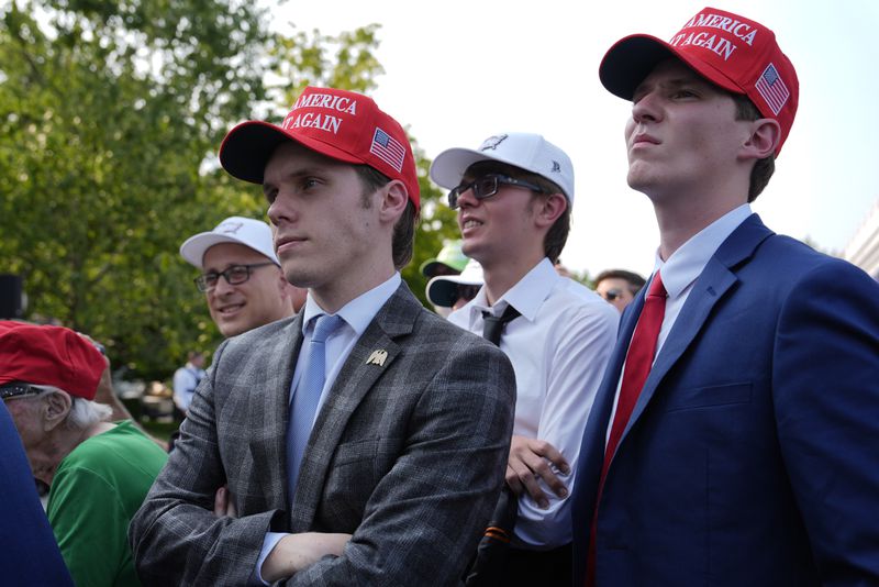 People listen as Republican presidential nominee former President Donald Trump speaks at a news conference at Trump National Golf Club, Thursday, Aug. 15, 2024, in Bedminster, N.J. (AP Photo/Julia Nikhinson)