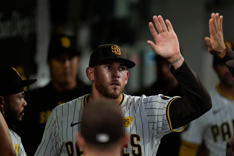 San Diego Padres starting pitcher Joe Musgrove is greeted by teammates after exiting during the fifth inning of a baseball game against the Pittsburgh Pirates, Monday, Aug. 12, 2024, in San Diego. (AP Photo/Gregory Bull)