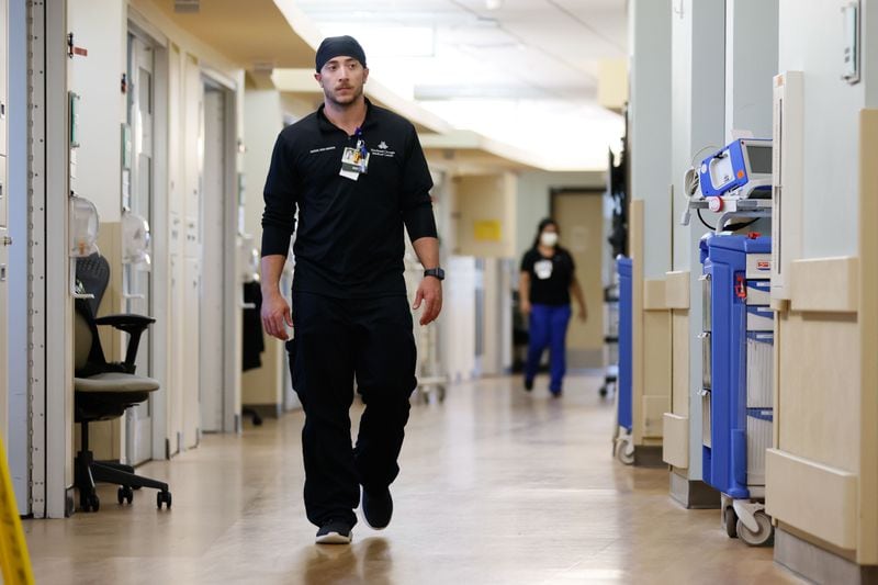 The registered nurse at Northeast Georgia Medical Center, Dylan Glass, walks between rooms with COVID-19 patients; the unit has sixteen beds occupied by COVID-19 patients, but the hospital administrators mentioned that they have seen a significant reduction in cases.
Miguel Martinez /miguel.martinezjimenez@ajc.com