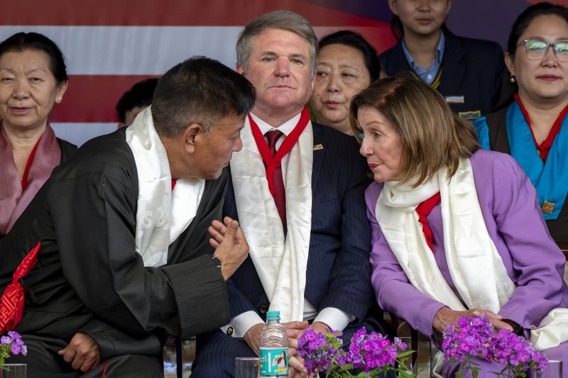 President of the Central Tibetan Administration, Penpa Tsering, left, speaks to Democratic former House Speaker Nancy Pelosi as Republican Rep. Michael McCaul, center, looks on at a public event during which the US delegation was felicitated by the President of the Central Tibetan Administration and other officials at the Tsuglakhang temple, in Dharamshala, India, Wednesday, June 19, 2024. (AP Photo/Ashwini Bhatia)