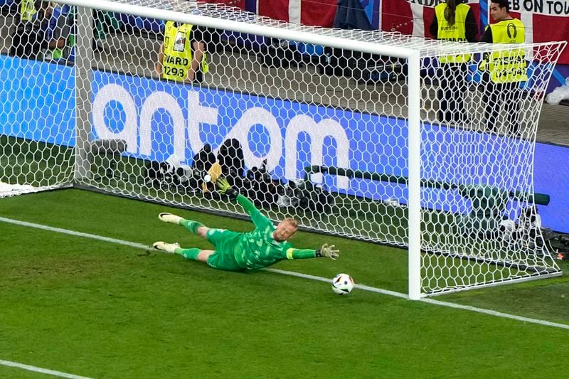 Denmark's goalkeeper Kasper Schmeichel dives but fails to save the goal from Germany's Kai Havertz during a round of sixteen match between Germany and Denmark at the Euro 2024 soccer tournament in Dortmund, Germany, Saturday, June 29, 2024. (AP Photo/Hassan Ammar)