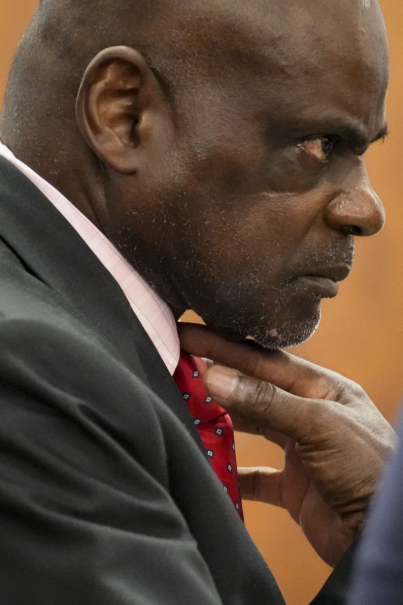 Retired Houston Police Department officer Gerald Goines adjusts his tie as his defense attorney is wrapping up the opening statement for his two felony murder charges in the January 2019 deaths of Dennis Tuttle and Rhogena Nicholas at the 482nd District Court Monday, Sept. 9, 2024 at Harris County Criminal Courthouse in Houston. (Yi-Chin Lee/Houston Chronicle via AP)