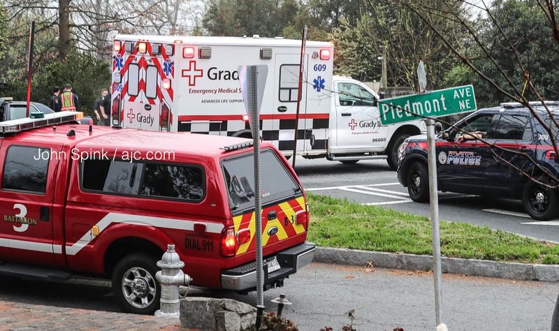 An ambulance pulls away from the scene of an officer-involved shooting near Piedmont Park on Tuesday morning.