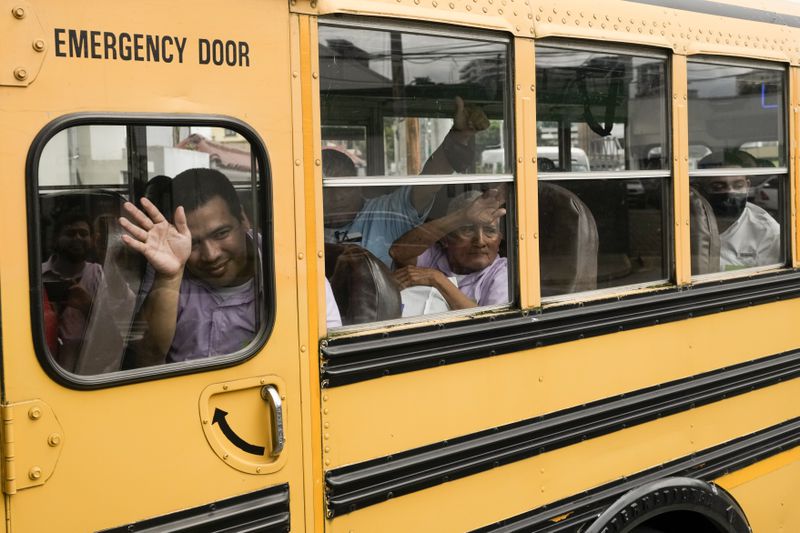 Nicaraguan citizens wave from a bus after being released from a Nicaraguan jail and landing at the airport in Guatemala City, Thursday, Sept. 5, 2024. (AP Photo/Moises Castillo)