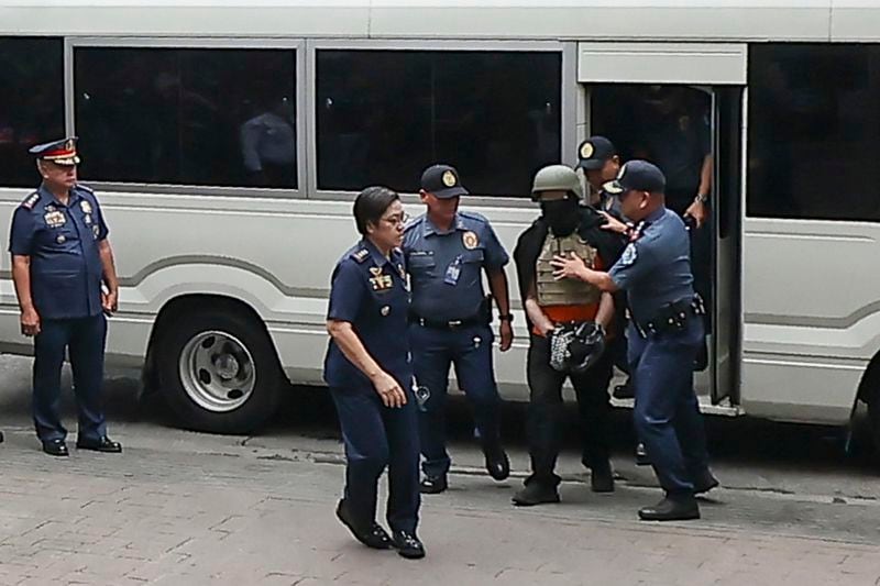 Apollo Carreon Quiboloy, wearing a helmet and flak jacket, a Filipino preacher charged with human trafficking, arrives at the Pasig Regional Trial Court in Pasig City, Philippines, Friday, Sept. 13, 2024. (AP Photo/Gerard Carreon)