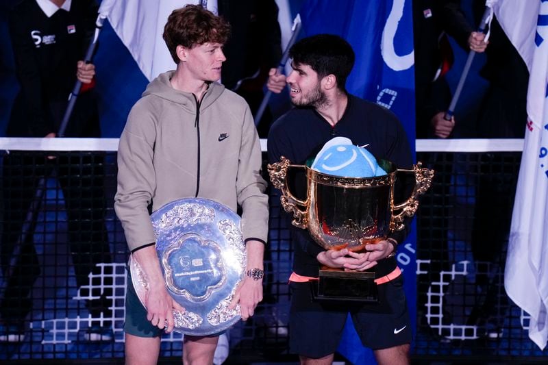 Carlos Alcaraz, right, of Spain talks with runner-up Jannik Sinner of Italy after winning their men's singles finals match of the China Open tennis tournament, at the National Tennis Center in Beijing, Wednesday, Oct. 2, 2024.(AP Photo/Andy Wong)