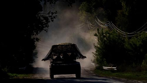 A Ukrainian armoured military vehicle travels near the Russian-Ukrainian border, Sumy region, Ukraine, Wednesday, Aug. 14, 2024. (AP Photo/Evgeniy Maloletka)