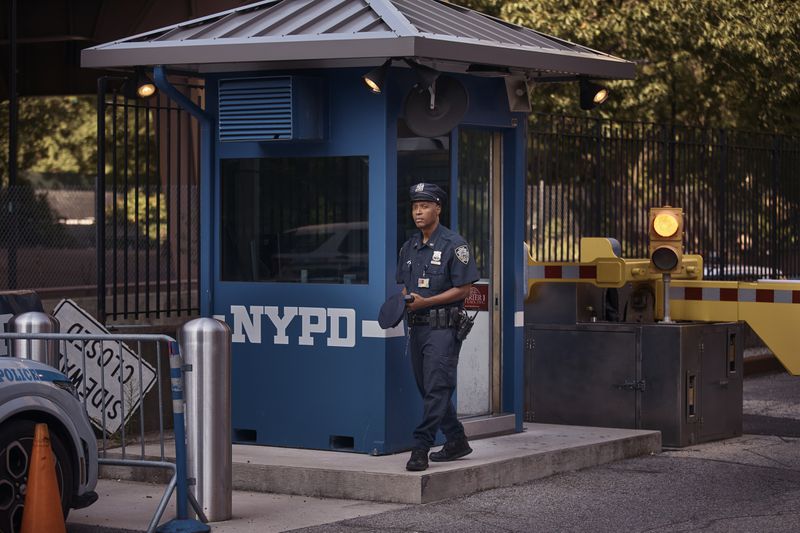 A police officer stands guard outside One Police Plaza NYPD Headquarters on Friday, Sept. 13, 2024, in New York. (AP Photo/Andres Kudacki)