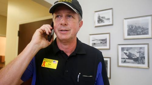 Walt Ehmer, then president and CEO of Waffle House, on the phone after landing at the Wilmington, N.C., airport with an emergency response team in the aftermath of Hurricane Irma on Sept. 17, 2018. Ehmer died Sept. 6 after a bout with cancer. (Steve Helber/AP)