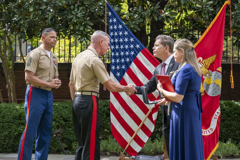 Commandant of the Marine Corps Gen. Eric Smith, center left, presents a the Navy and Marine Corps Medal and citation to Bart Collart and his wife, Alexia, the parents of Cpl. Spencer Collart, during a ceremony on Monday, Sept. 16, 2024 in Washington. (AP Photo/Kevin Wolf)