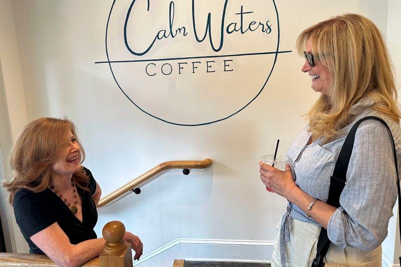 Lynn Natale, 62, right, of Newtown in Bucks County, Pa., talks to her friend Terry Sykes at a Newtown, Pa., coffee shop on June 14, 2024. Natale says she thinks Donald Trump struggles to communicate with women, but "the alternative is unacceptable," referring to Democratic President Joe Biden. (AP Photo/Thomas Beaumont)
