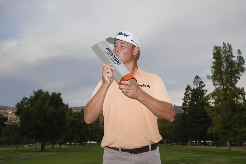 Patton Kizzire kisses the trophy after winning the Procore Championship golf tournament at Silverado Resort North Course, Sunday, Sept. 15, 2024, in Napa, Calif. (AP Photo/Godofredo A. Vásquez)