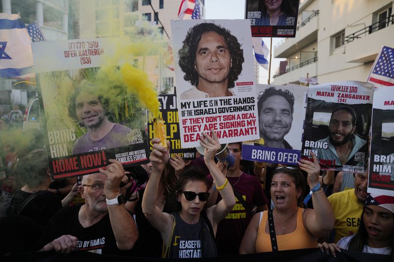 Relatives of hostages held by Hamas in the Gaza Strip and their supporters protest near the hotel where U.S. Secretary of State Antony Blinken is staying during his visit with Israeli Prime Minister Benjamin Netanyahu and leadership about a deal to halt the war in Gaza and free the hostages, in Tel Aviv, Monday, Aug. 19, 2024. (AP Photo/Ohad Zwigenberg)