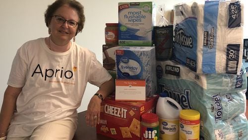 Susan O’Dwyer of Alpharetta shows off donated items for victims of Hurricane Michael. She has been leading such humanitarian efforts since 2005. CONTRIBUTED