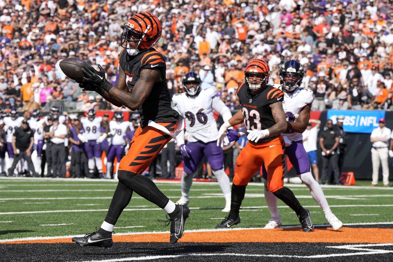 Cincinnati Bengals wide receiver Tee Higgins, left, catches a touchdown pass against the Baltimore Ravens during the second half of an NFL football game, Sunday, Oct. 6, 2024, in Cincinnati. (AP Photo/Jeff Dean)