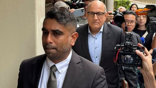 Former Transport Minister S. Iswaran, left, and his lawyer Mr. Navin Thevar arrive at the High Court in Singapore, July 5, 2024. (AP Photo)