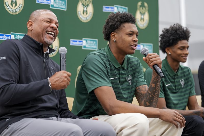 Milwaukee Bucks 2024 draft picks AJ Johnson and Tyler Smith laugh with head coach Doc Rivers at a news conference Tuesday, July 2, 2024, in Milwaukee. (AP Photo/Morry Gash)