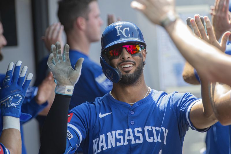 Kansas City Royals' MJ Melendez is congratulated by his teammates after hitting a three-run home run off Cleveland Guardians relief pitcher Eli Morgan during the fourth inning of the first game of a baseball doubleheader in Cleveland, Monday, Aug. 26, 2024. (AP Photo/Phil Long)