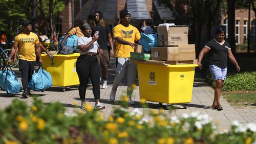 The family of Kennesaw State University first year student Destiny Smith (not pictured), of McDonough, helps her move into her room at University Village on the Kennesaw campus on Wednesday. It was the first day of move-in for the Fall 2024 semester, which begins August 12th. (Jason Getz / AJC)
