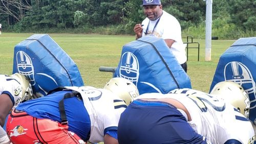 Drew coach Steve Robinson works with the offensive line at practice on Sept. 18, 2024, at Drew High School.