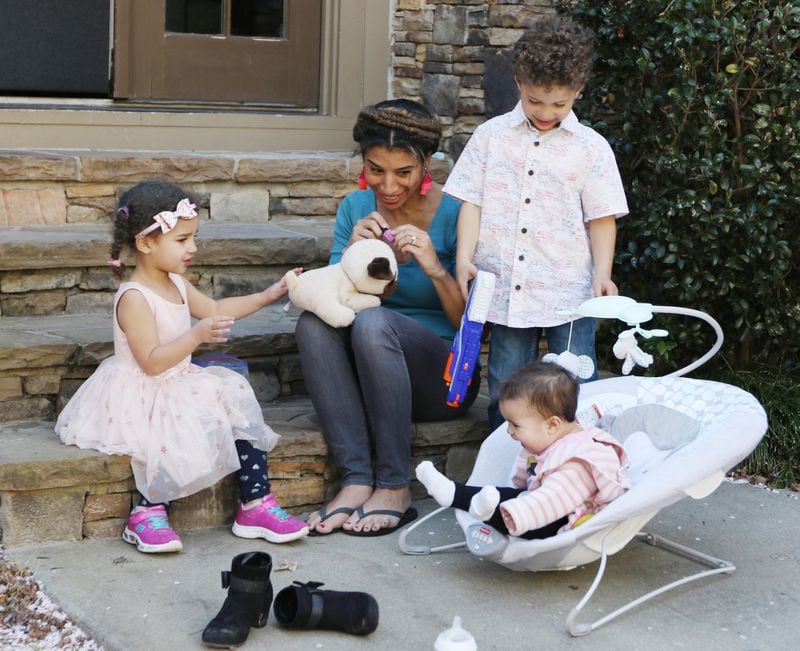Debra Shigley, who has five children under age 8, plays with her children in their backyard in Atlanta. EMILY HANEY / EMILY.HANEY@AJC.COM