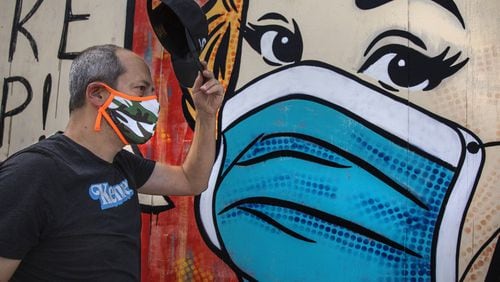 Neal Brandenburg walks by a mural painted by artist Sara Sandoval on Traction Avenue near 3rd Street in Los Angeles. (Mel Melcon / Los Angeles Times/TNS)