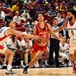 Atlanta Hawks forward Zaccharie Risacher (10) drives to the basket against Washington Wizards forward Kyshawn George (18) and forward Justin Champagnie during the second half of an NBA summer league basketball game Friday, July 12, 2024, in Las Vegas. (AP Photo/David Becker)
