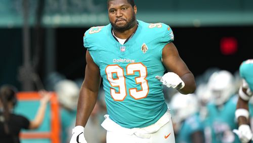 Miami Dolphins defensive tackle Calais Campbell (93) comes through the tunnel before a preseason NFL football game against the Washington Commanders, Saturday, Aug. 17, 2024, in Miami Gardens, Fla. (AP Photo/Wilfredo Lee)