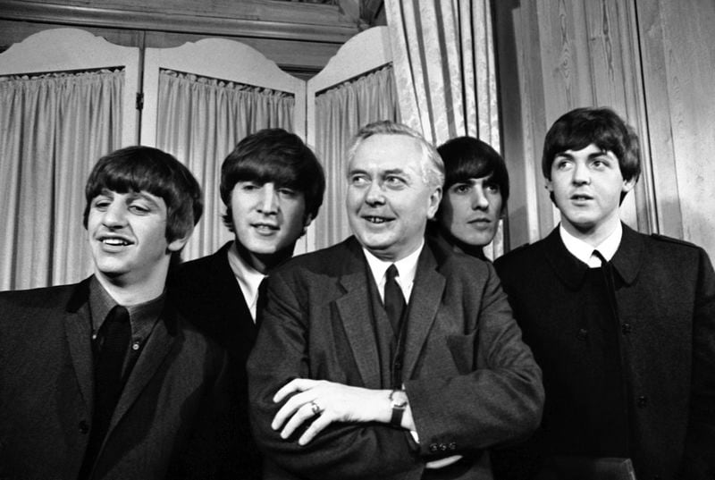 FILE - Britain's Labour Party leader Harold Wilson with the Beatles, from left Ringo Starr, John Lennon, George Harrison, and Paul McCartney, during the Variety Club of Great Britain's Show Business Personality award for 1963 presentation ceremony in London, England, March 19, 1964. Britain’s upcoming general election on July 4, 2024 is widely expected to lead to a change of government for the first time in 14 years. In 1964, the Conservative Party had been in power for 13 years and was on its fourth prime minister. The election was a race between the aristocratic Douglas-Home and Labour leader Harold Wilson, a young politician who was buzzing with ideas such as the need to harness the “white heat of technology” to modernize the ailing British economy. (AP Photo/File)