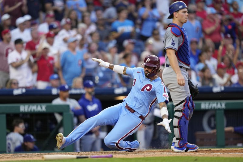 Philadelphia Phillies' Nick Castellanos, left, scores past Los Angeles Dodgers catcher Will Smith on a triple by Brandon Marsh during the sixth inning of a baseball game, Thursday, July 11, 2024, in Philadelphia. (AP Photo/Matt Slocum)