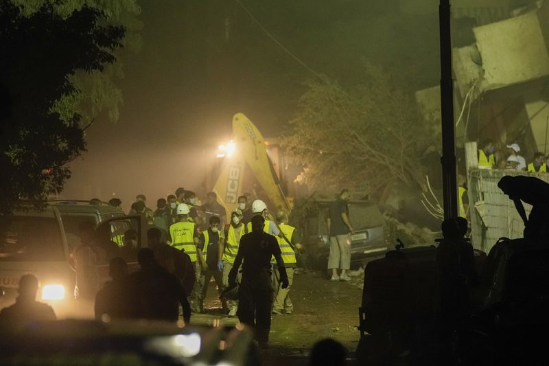 Rescuers arrive at the site of an Israeli airstrike in Beirut's southern suburbs Friday, Sept. 27, 2024. (AP Photo/Bilal Hussein)