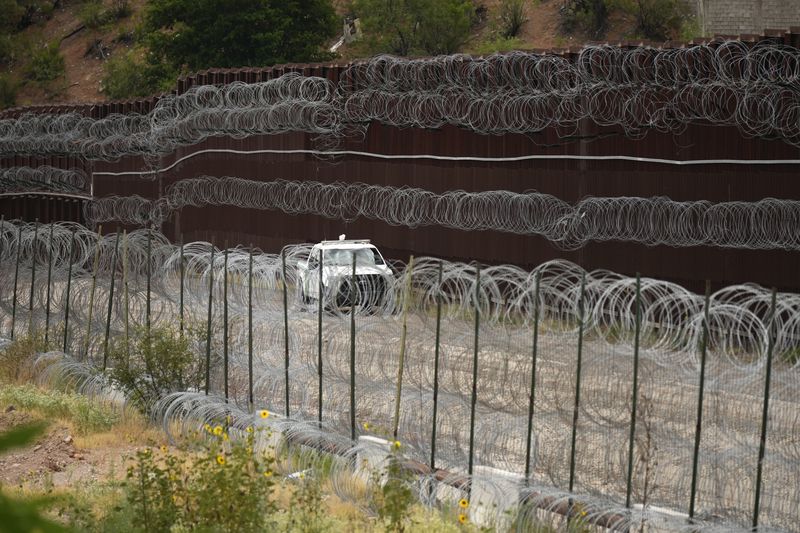 FILE - A vehicle drives along the U.S. side of the US-Mexico border wall in Nogales, Ariz., June 25, 2024. (AP Photo/Jae C. Hong, Pool, File)