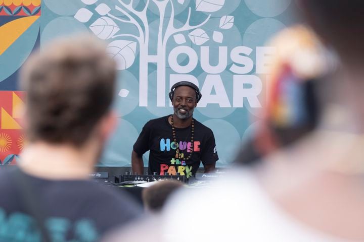 DJ Kemit looks up and smiles at the dancing crowd during the 20th anniversary of the House In The Park music festival in Grant Park in Atlanta on Sunday, Sept. 1, 2024. (Ben Gray / Ben@BenGray.com)