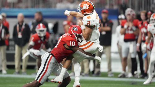 Clemson quarterback Cade Klubnik (2) is hit by Georgia linebacker Damon Wilson II (10) after releasing a pass during the second half of an NCAA college football game Aug. 31, 2024, in Atlanta. (AP Photo/John Bazemore)