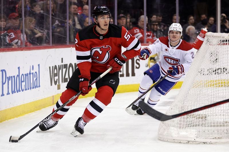 FILE - New Jersey Devils defenseman Cal Foote (52) skates with the puck against the Montreal Canadiens during the first period of an NHL hockey game Jan. 17, 2024, in Newark, N.J. Four current members of the National Hockey League charged with sexual assault in Canada will become free agents after not receiving qualifying offers from their respective teams. Carter Hart was under contract with Philadelphia, Michael McLeod and Foote with New Jersey and Dillon Dube with Calgary when they were charged in connection with an incident that occurred in London, Ontario, in 2018 after they were teammates on Canada's world junior team. (AP Photo/Adam Hunger, File)