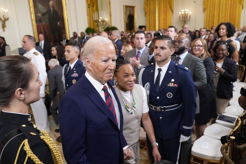 President Joe Biden walks with Dawn Staley, Coach of the University of South Carolina Women's basketball team, following an event in the East Room of the White House in Washington, Tuesday, Sept. 10, 2024, to welcome the University of South Carolina Gamecocks Women's basketball team and celebrate their 2023-2024 NCAA championship season. (AP Photo/Susan Walsh)